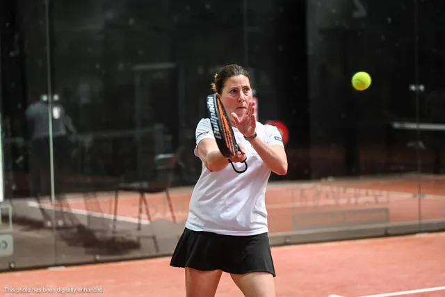 A player watching the ball onto her racket
