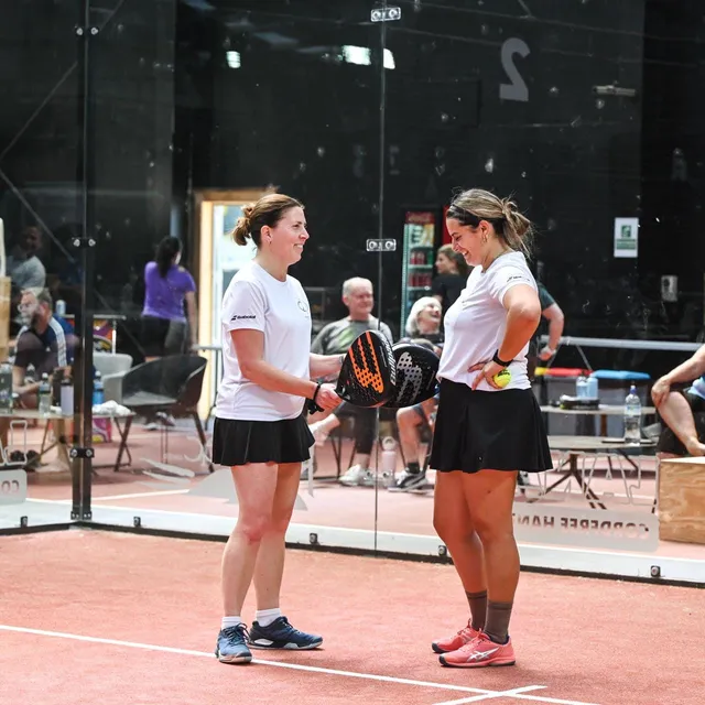 Two partners talking tactics between points
