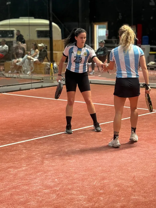 Two partners in Argentina shirts between points