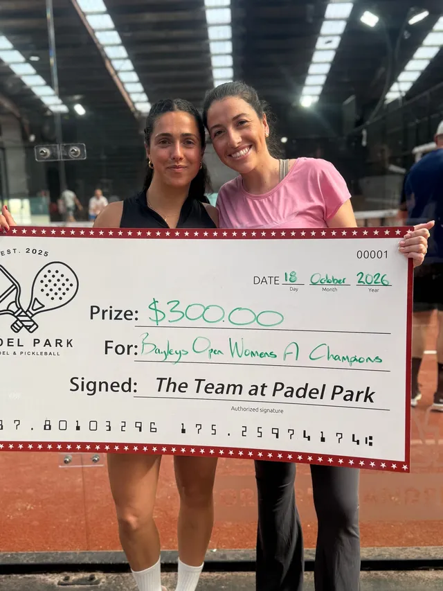 The Women's A champions holding their prize cheque