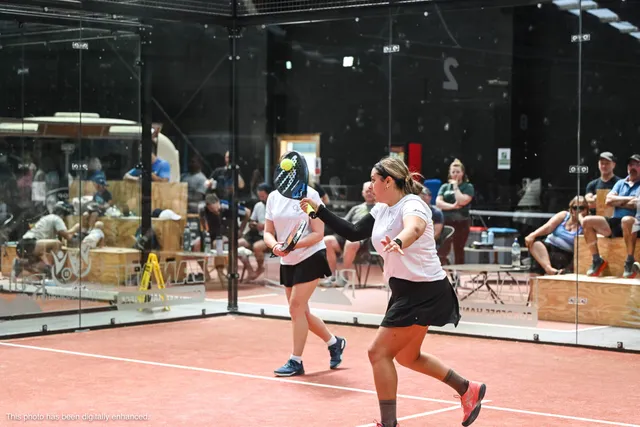 Doubles partners moving up together with the crowd behind