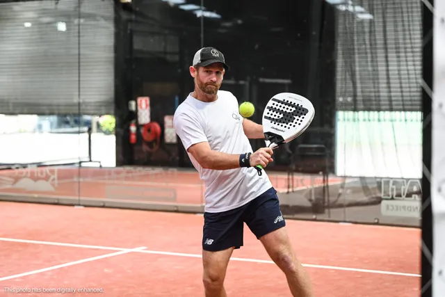 A player in a cap shaping up for a forehand