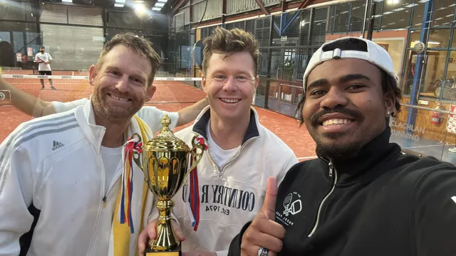 Three players taking a selfie with a trophy