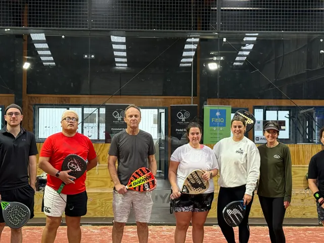 A group of players with their rackets lined up after a game