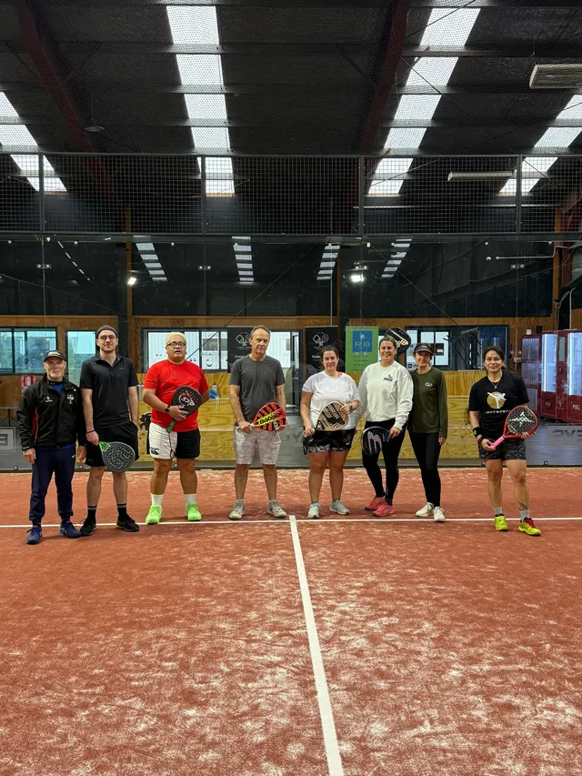 A group standing together on court after playing