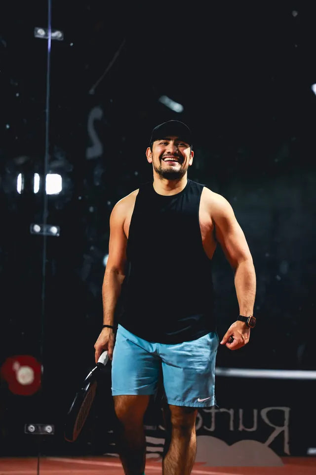 A player in a black singlet walking on court