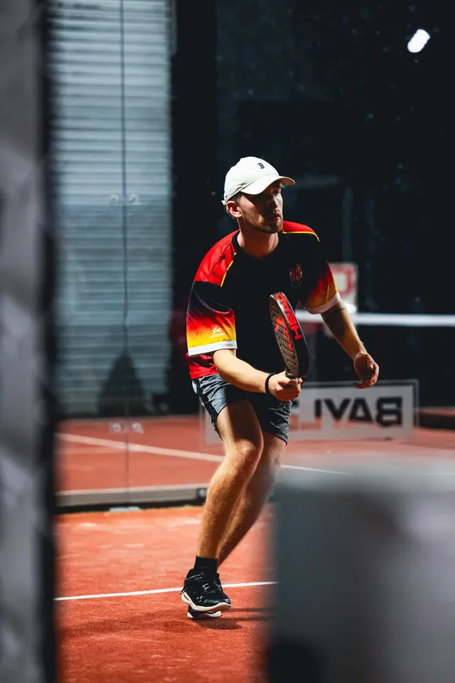 A player lining up a forehand by the glass