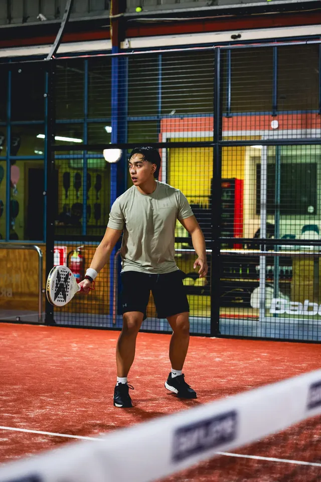 A player setting up for a shot on a court with the lights on