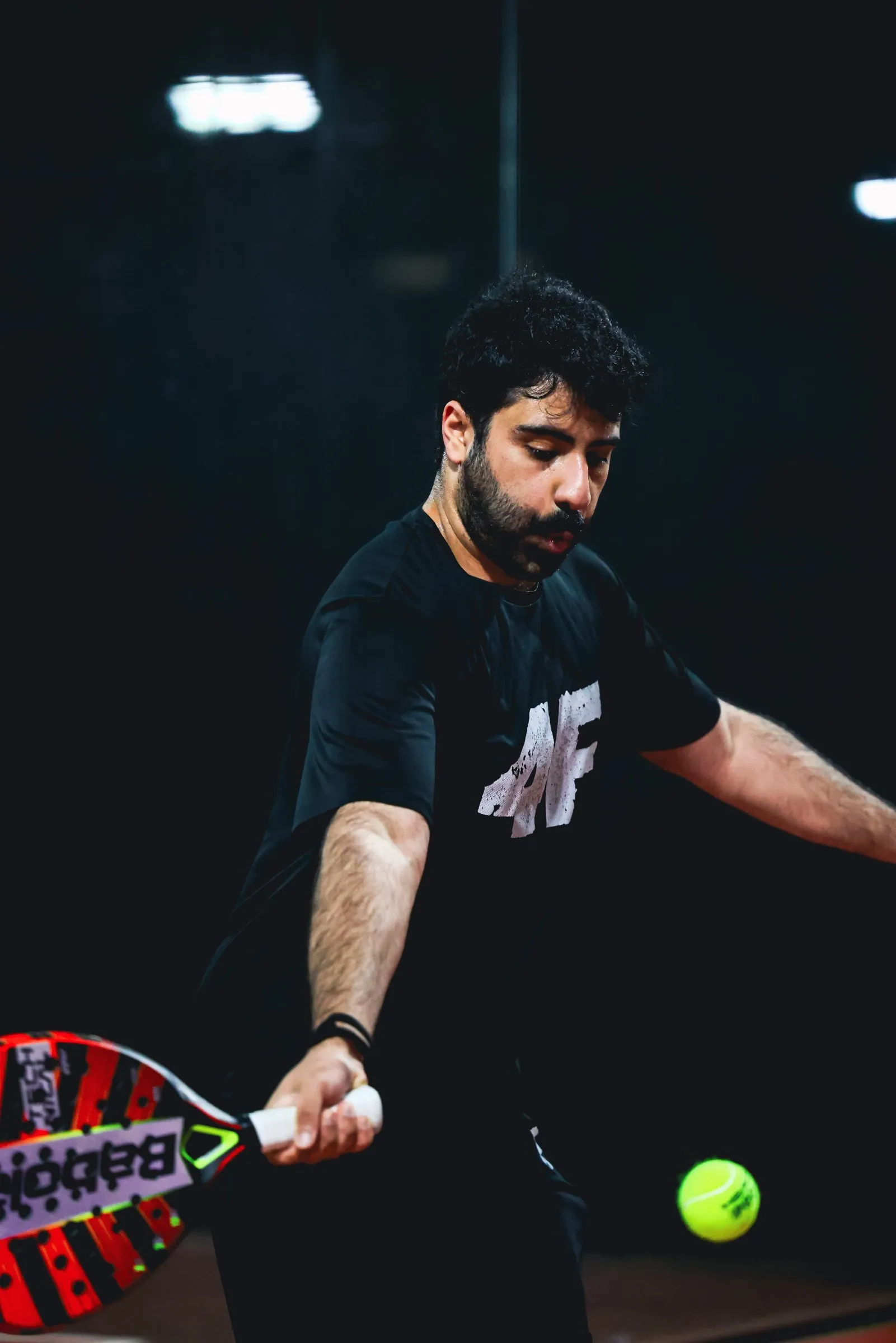 Close-up of a padel racket meeting the ball