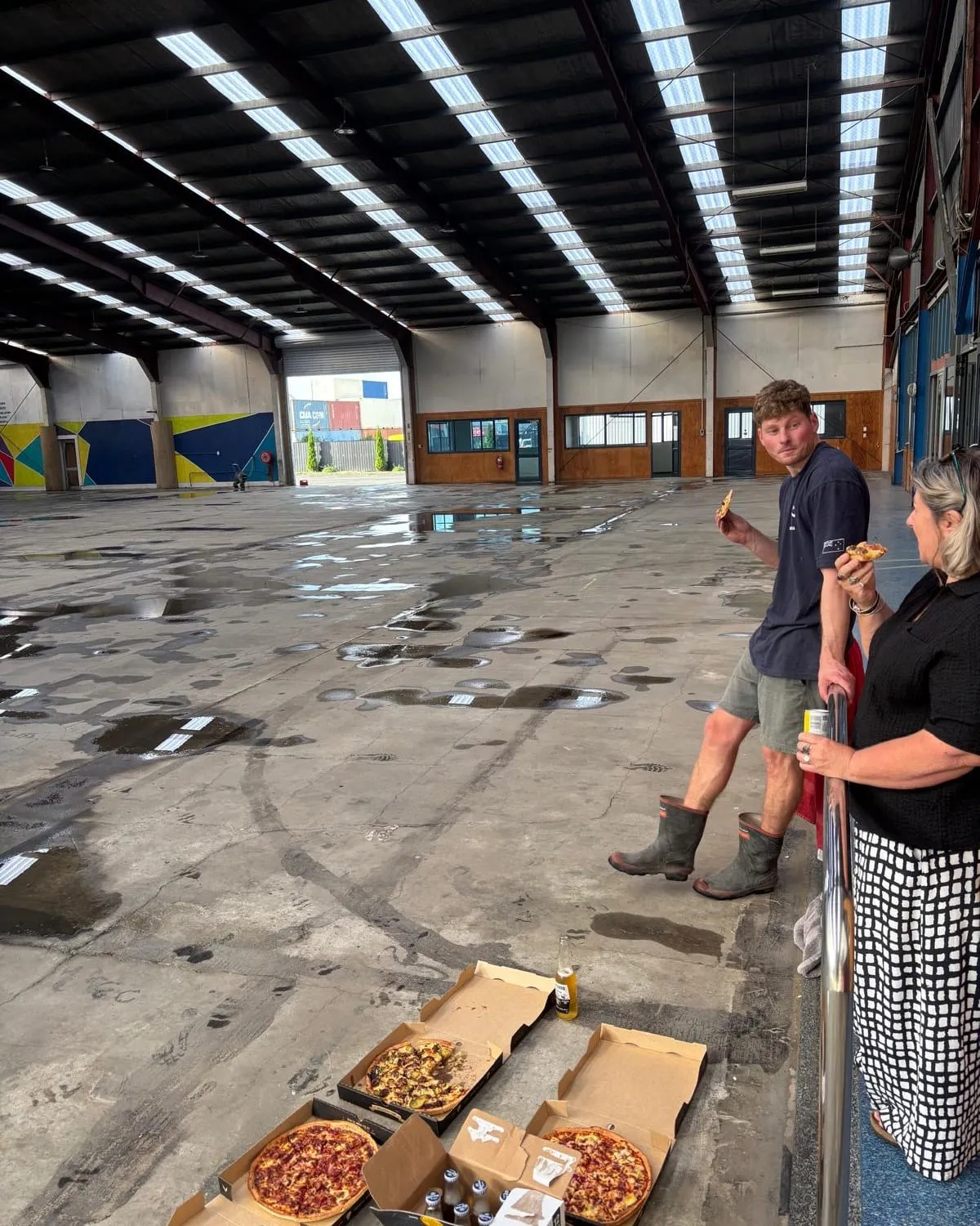 A pizza break in the empty warehouse before the build