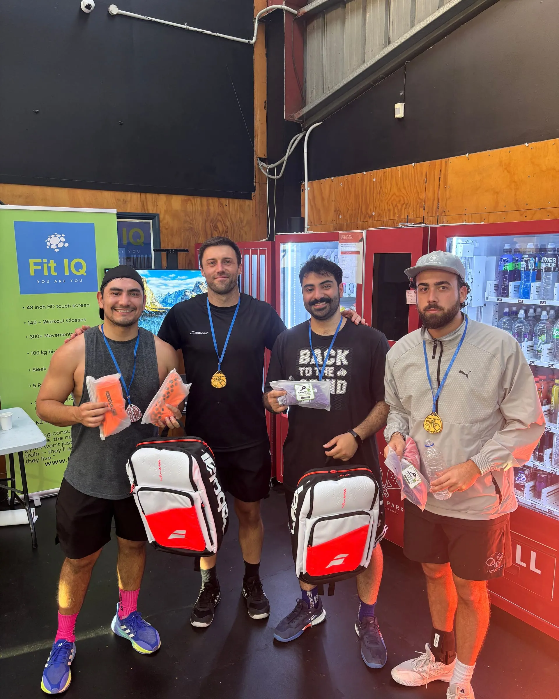Four players with medals and prize bags at the Park