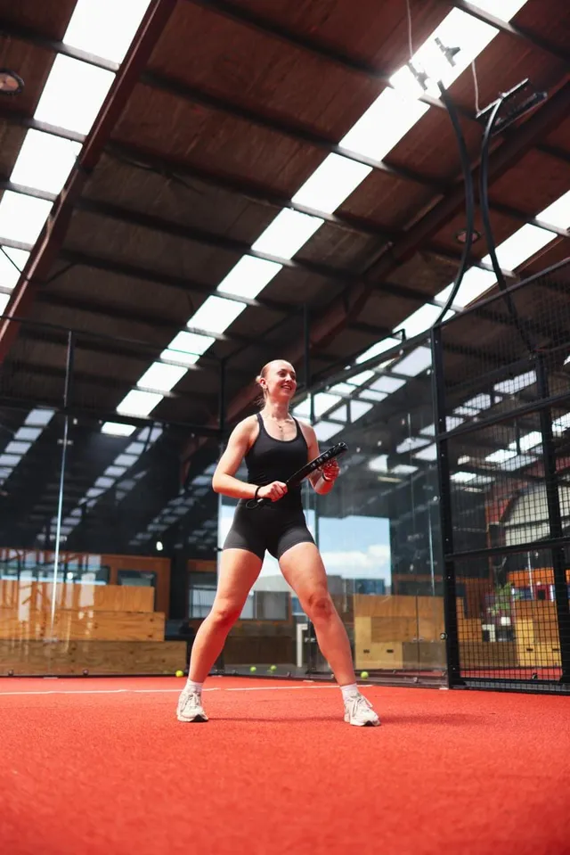 A player ready at the baseline in daylight