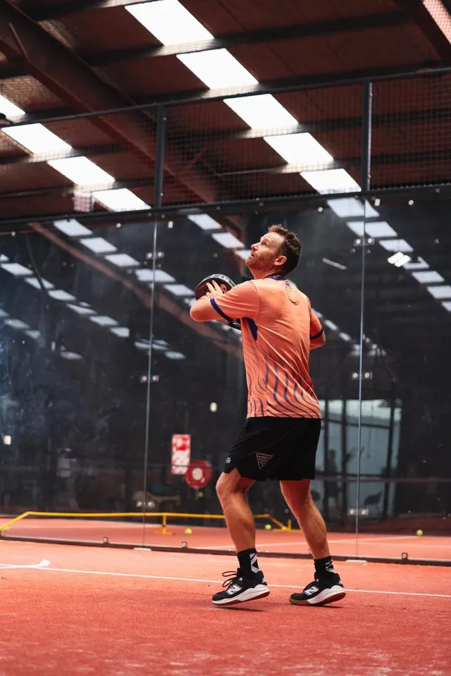 A player tossing the ball to serve