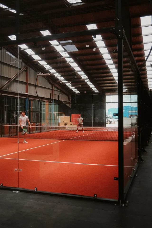 Looking down the glass padel courts in daylight